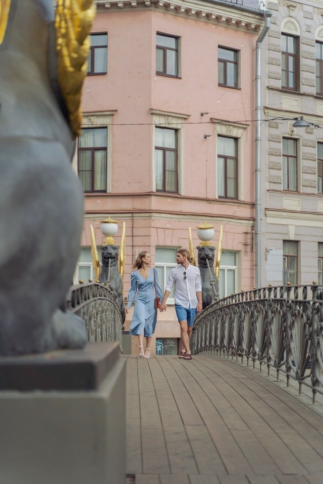 A couple walking across a rope bridge